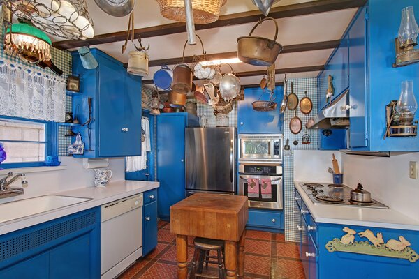 Blue kitchen with pots on the ceiling