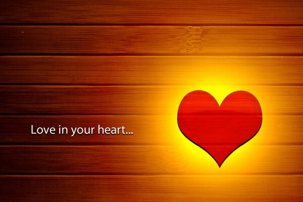 Glowing heart on the background of wooden boards