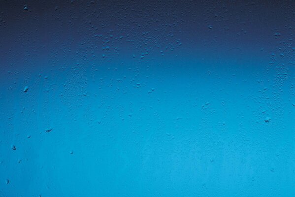 Raindrops on a blue window background