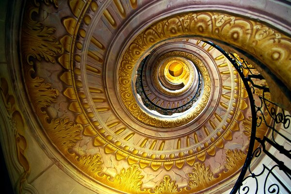 Spiral staircase with golden patterns