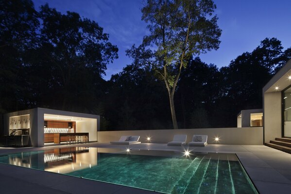 Sun beds near the pool with kitchen