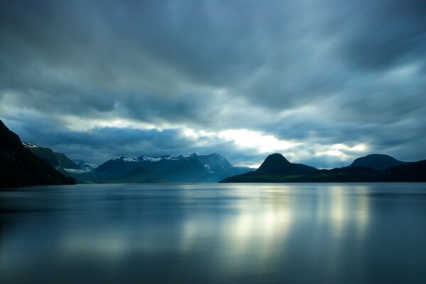 A water surface surrounded by mountains