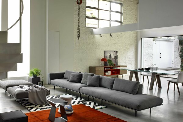 Designer apartment with grey sofa and red carpet