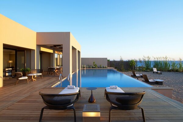 Two sun loungers on the background of the pool