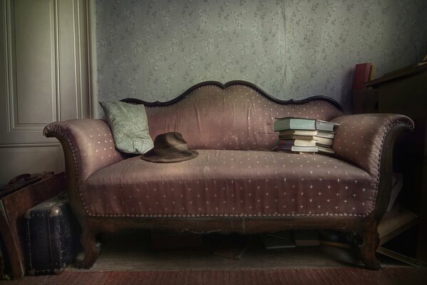 An old sofa with an old suitcase