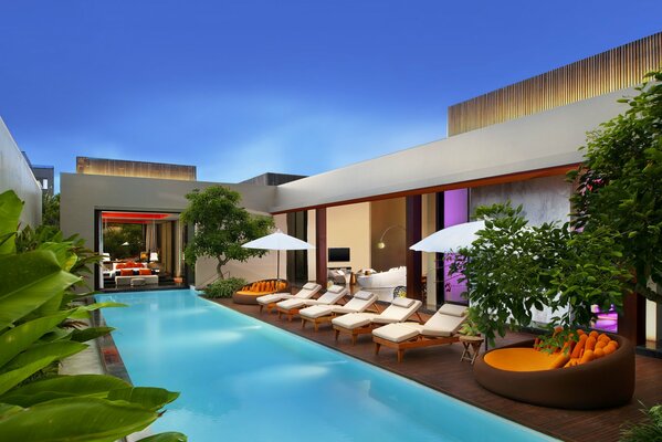 Chill-out area with a pool with sun loungers at the villa