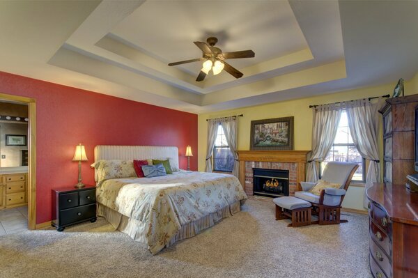 Interior with a fireplace in the bedroom and a comfortable armchair