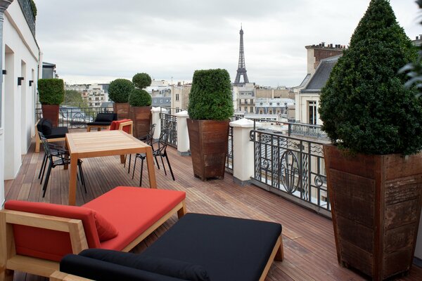 Terrace with furniture on the background of the tower