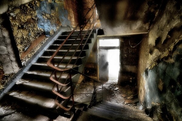 An old staircase in the entrance of a dilapidated building