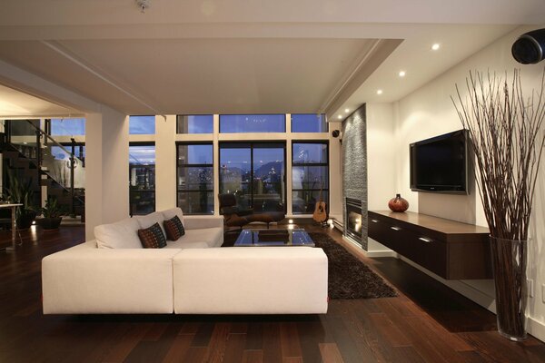 The interior of a spacious living room with a white sofa