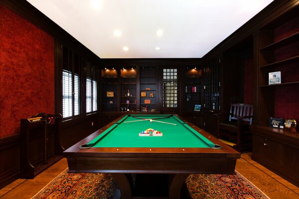 A brown room with a billiard table