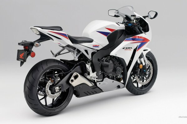 Honda sports motorcycle in tricolor on a solid background