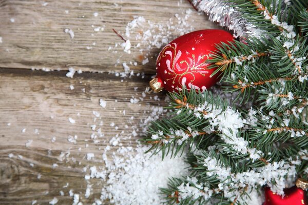 Christmas tree toys on a branch in the snow