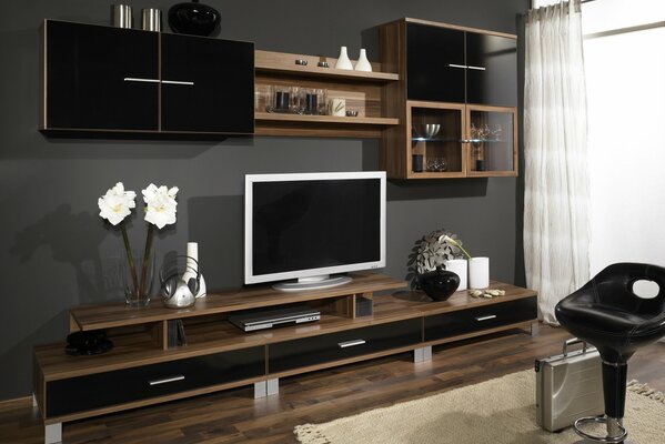 A wall in black and brown tone with a TV