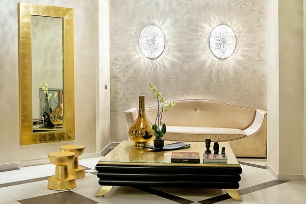 A golden mirror and a table with an orchid