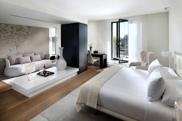 A white bedroom with a balcony. minimalistic design