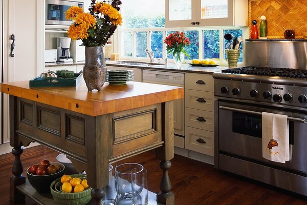 The interior of a stylish kitchen with a table in the center