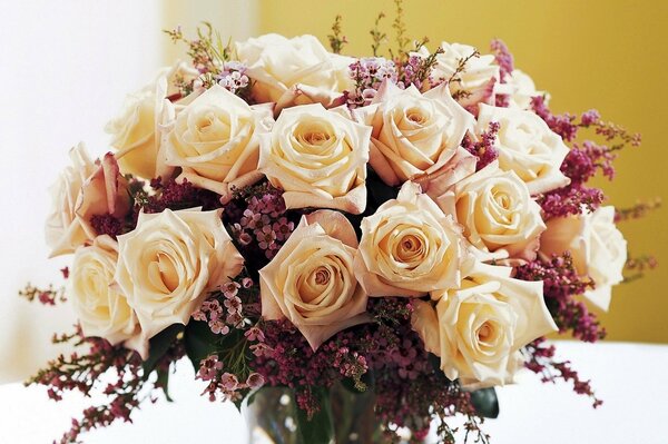 A large bouquet of white roses in a vase on the table