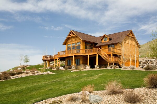 Cozy house on a hill under a blue sky