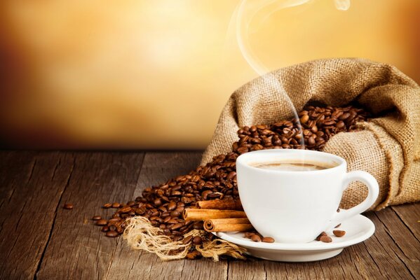 Hot coffee with cinnamon in a white saucer