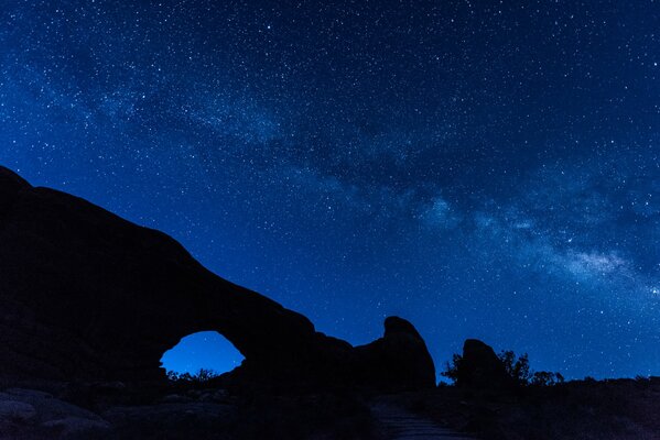 Mountains against the background of the night starry sky, the Milky Way is visible