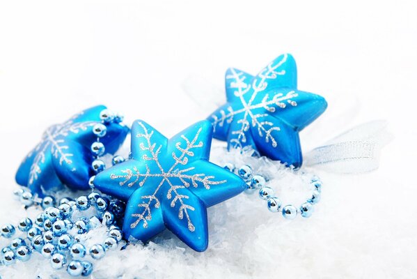 Christmas tree toys in blue with beads on a light background