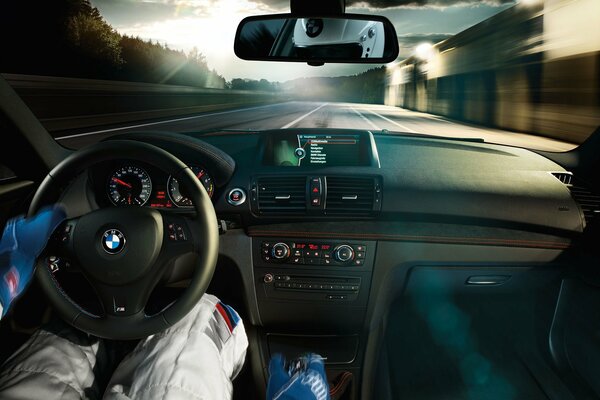 A racer rides in a BMW on the highway