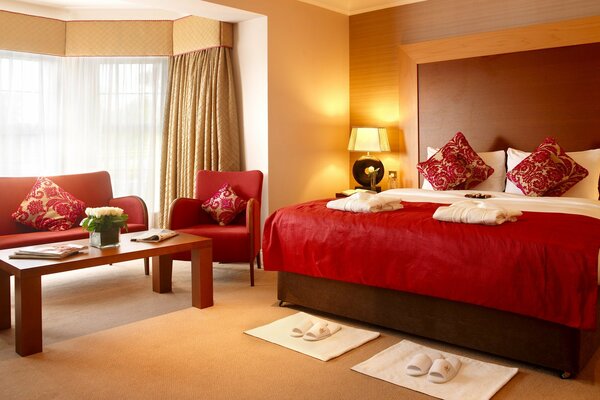 The interior of a cozy bedroom in red tones