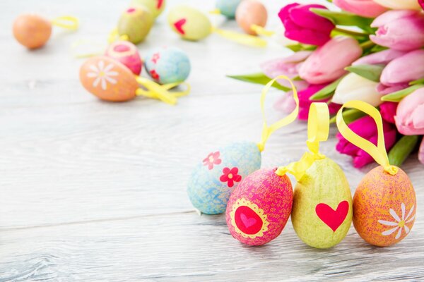 Easter decorated eggs on a background of tulips