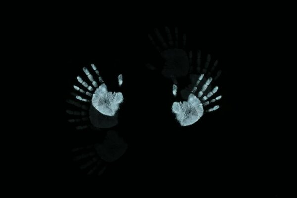 Palm prints on a black background