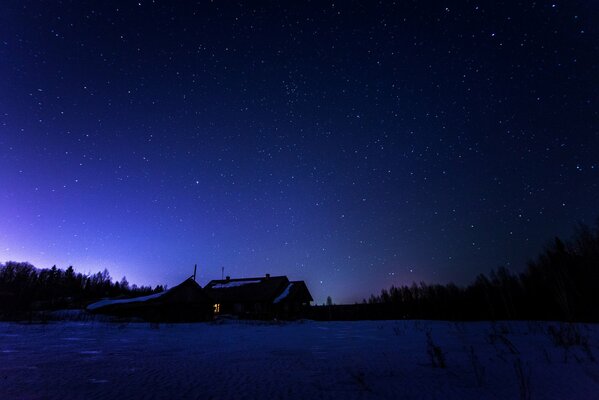 The starry sky in winter over a lonely house