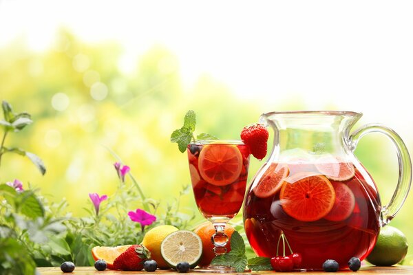 Fruit and berry compote in a glass and decanter