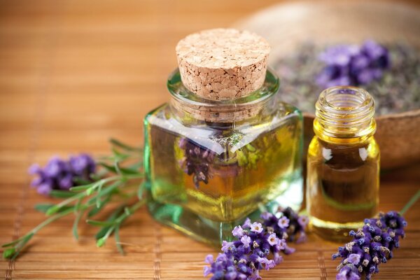 Lavender oil in glass jars and lilac twigs