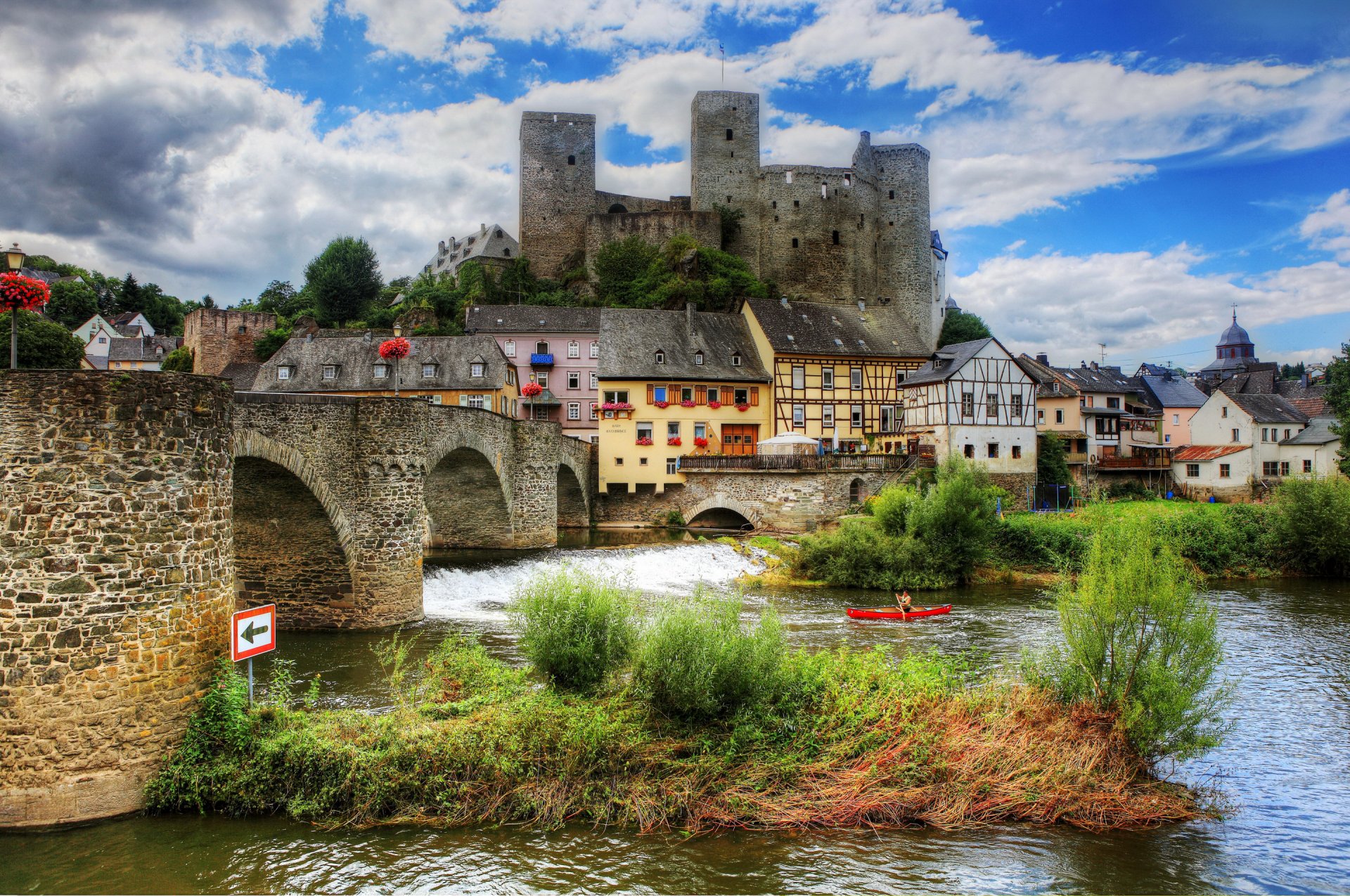 runkel germany sky clouds river bridge grass boat house hill castle tower people