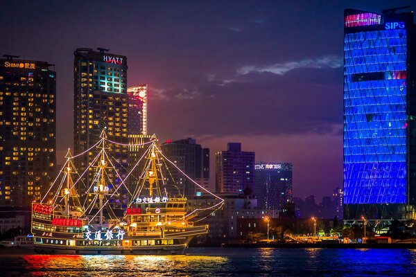 Illuminated ship approaches the wharf China