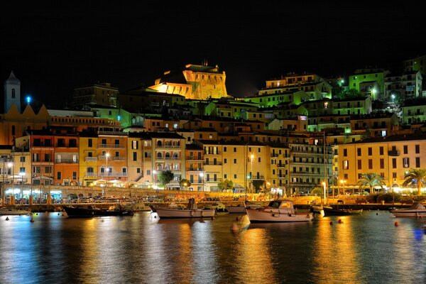 Night Italian city on the shore of the harbor