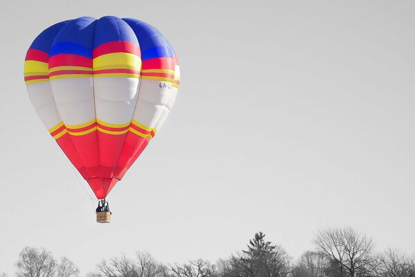 A large balloon on a cloudy sky background