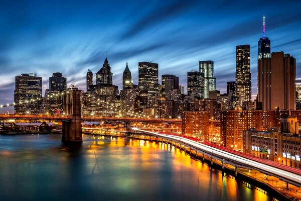 Les lumières de la nuit de New York. Vue sur le pont de Brooklyn et les gratte-ciel illuminés. Lumières de la grande ville