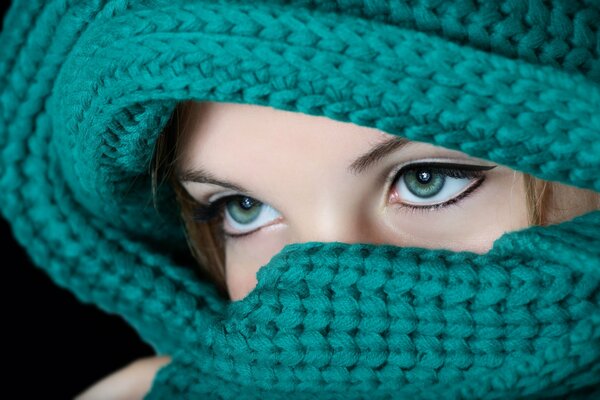 Girl wrapped in a scarf close-up