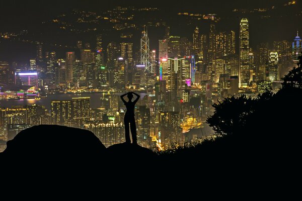 Silhouette of a girl against the background of a night city
