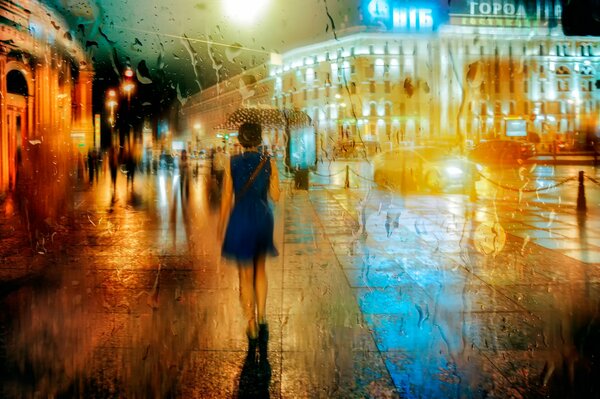 Chica caminando por la calle lluviosa