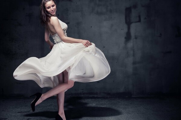 Model in a beautiful dress parapet in a dark room