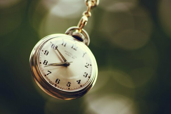 Elegant watch with hands on a blurry background