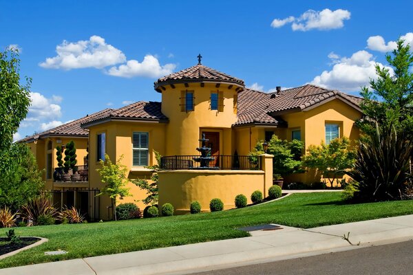 Yellow mansion. Landscaping, green lawn