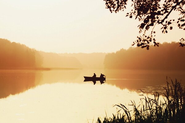 Boat on the lake in the morning haze
