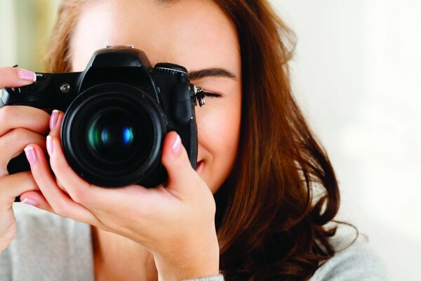 The photographer girl looks into the lens