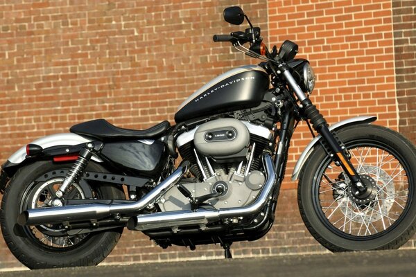 A motorcycle parked against the background of a brick building