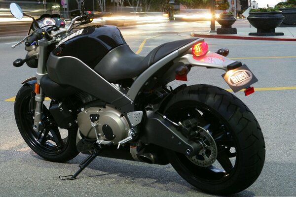 Incredibly attractive black bike in the hustle and bustle of the city