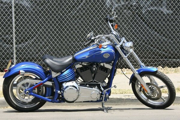 Harley Davidson motorcycle on the background of a fence