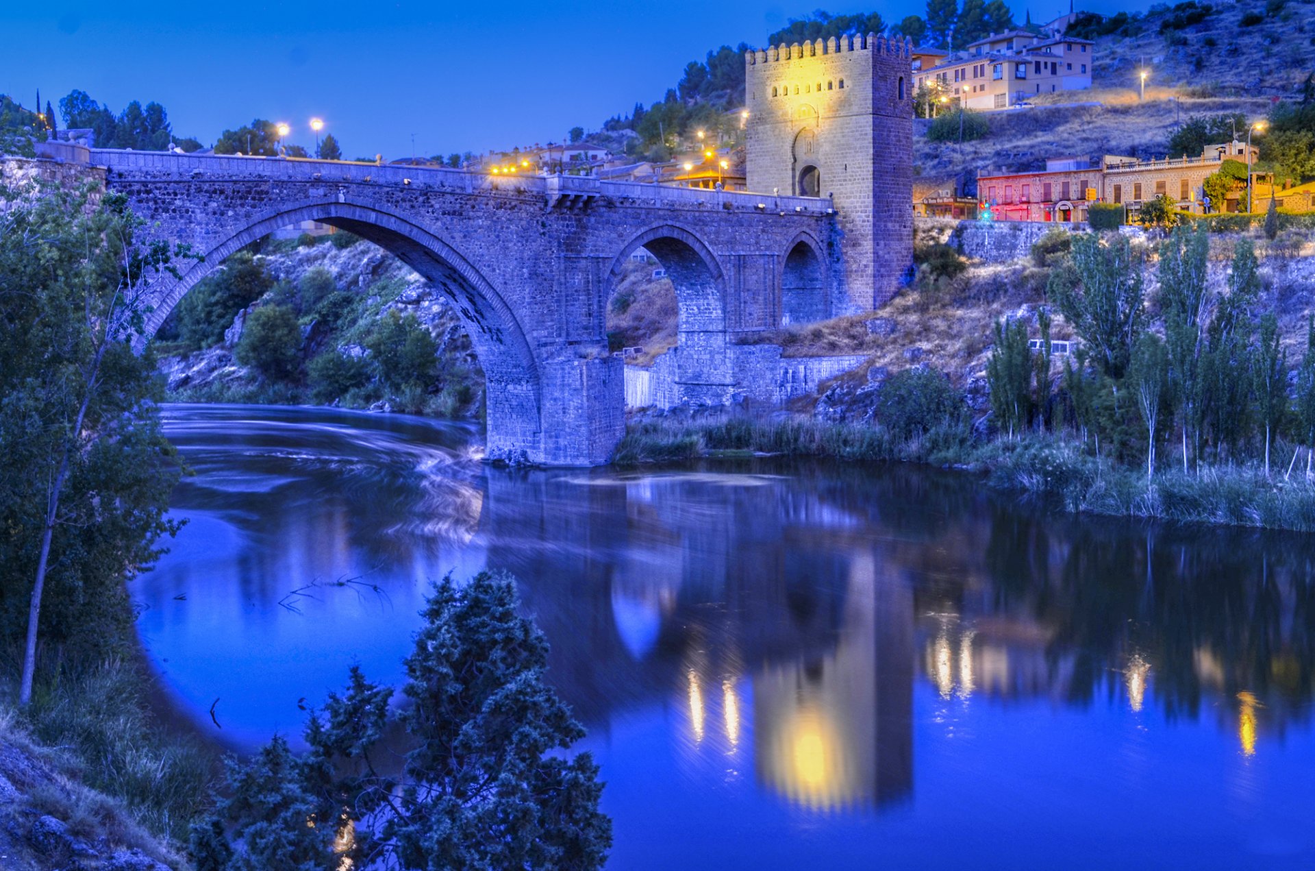 puente de san martin toledo spain river bridge night lights slope house tower sky